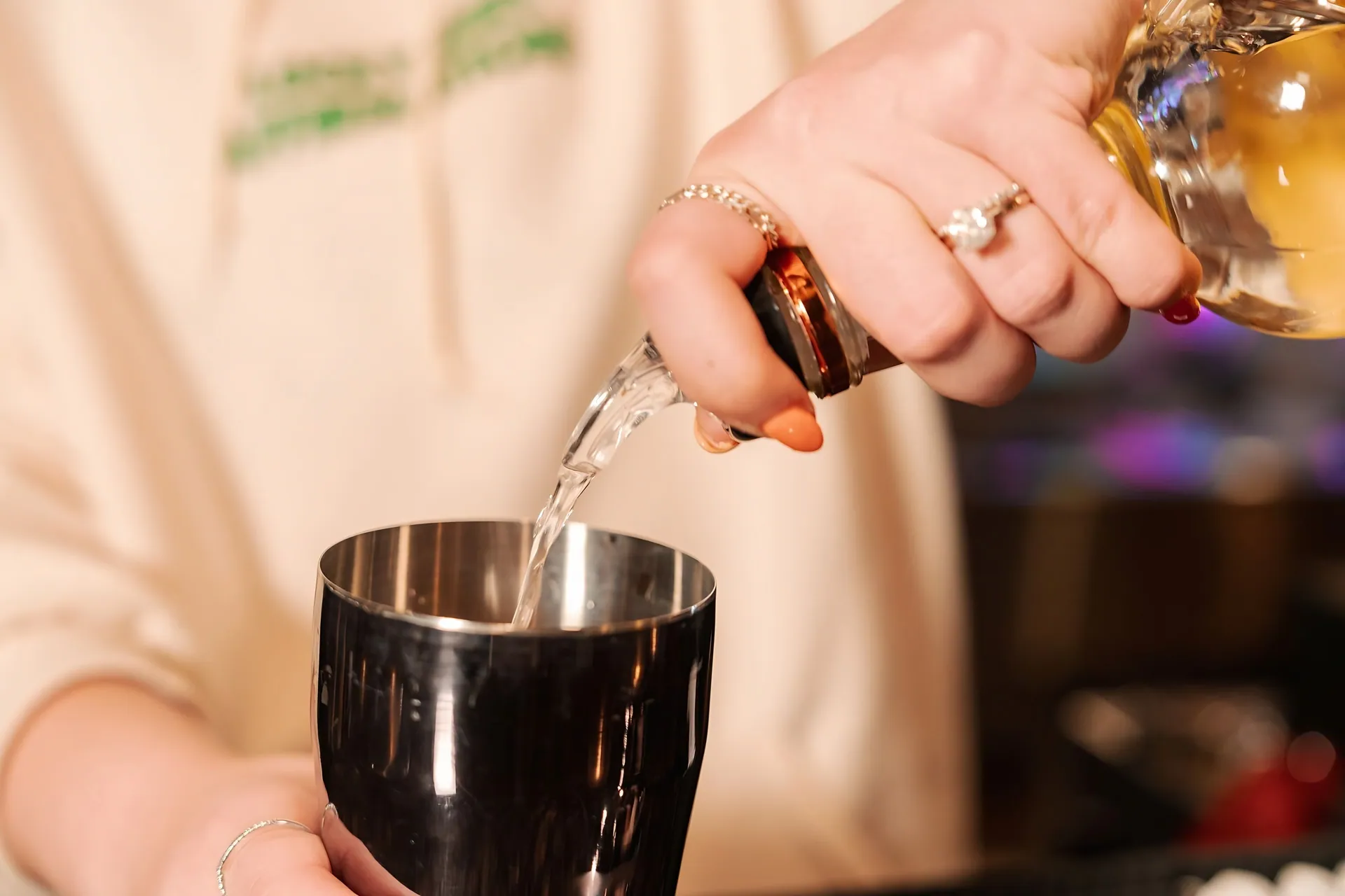 A bantr bartender pouring a drink at bantr grand hotel